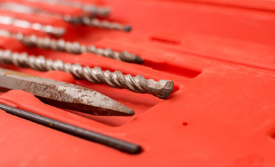   old drill tools on red background