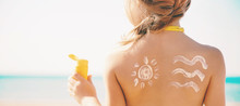 Child On The Beach Smears Sunscreen. Selective Focus.