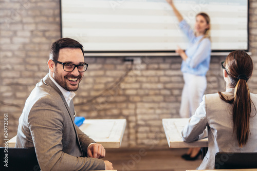 Fotomural Confident speaker giving public presentation using projector in conference room