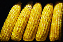 Close-up Of Ripe Boiled Yellow Corn For Sale Inside A Glass Vitrine Against A Black Background, Seen On Boracay, Philippines