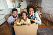 © Mediteraneo - African American family, parents and daughter, unpacking boxes and moving into a new home, having fun.