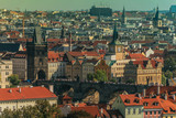 Fototapeta Miasto - View of Charles bridge and the old town of Prague in Czech Republic, at the banks of Vltava River under the sunset