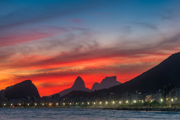 Fototapete - Night View of Copacabana Beach With Beautiful Red Sky Just After the Sunset, and Mountains in the Horizon, in Rio de Janeiro, Brazil