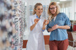 Professional optician helping to choose glasses for better eyesight