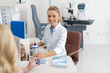 © Yakobchuk Olena - Friendly ophthalmologist prescribing contact lenses for patient