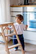 © Masson - Little toddler boy stay at kitchen