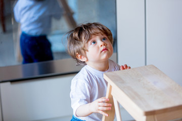 little toddler boy stay at kitchen