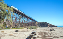 Railroad Train Going Over Railroad Track Bridge At Gaviota Beach On The Central Coast Of California United States