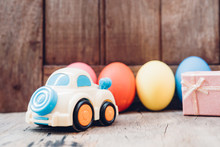 Easter Egg And Toy Car On Wooden Background