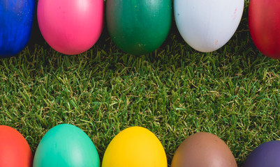 Easter eggs clean frame on green grass background