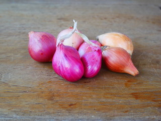 organic shallots,fresh shallots on wood background,Chinese onion