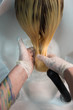 © strigana - Beauty concept - Professional hairdresser applying shampoo, washes color paint off and massaging hair of a customer. Woman having her hair washed in a hairdressing beauty salon