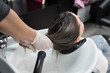 © strigana - Beauty concept - Professional hairdresser applying shampoo, washes color paint off and massaging hair of a customer. Woman having her hair washed in a hairdressing beauty salon