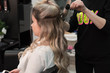 © strigana - Professional hairdresser makes curls using curling