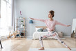 © BestForYou - Attractive woman practicing yoga at home interior.