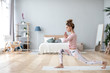 © BestForYou - Attractive young woman working out on white mat at home.