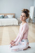 © BestForYou - Woman practicing home yoga.
