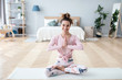 © BestForYou - Beautiful smiling woman in lotus pose on yoga mat.