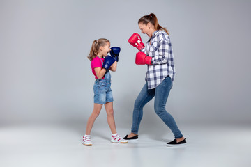 Fitness woman and her daughter are boxing