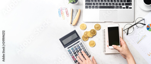 Cuadros en Lienzo A woman is calculating the fee, profit and doing a payment online on a modern ma