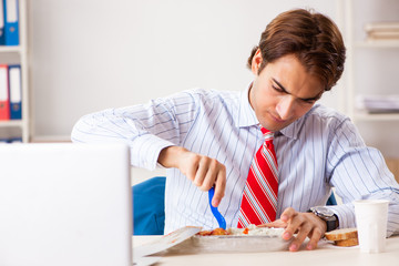 Wall Mural - Man having meal at work during break