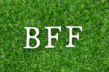 Poster - Wood letter block in word BFF (Abbreviation of best friend forever) on artificial green grass background