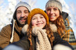 © Seventyfour - Closeup portrait of happy family posing looking at camera in beautiful winter forest