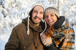 © Seventyfour - Waist up portrait of happy adult couple having fun in winter forest  and smiling, copy space