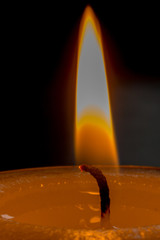 burning candle with flame bathing in wax