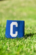 Blue soccer Captain armband, closeup on football pitch grass