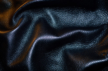 Textured crumpled black leather close-up