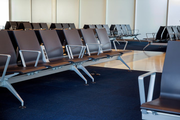 Wall Mural - Empty airport departure lounge terminal waiting area with chairs