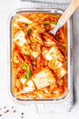 Wall Mural - Kimchi cabbage in glass container, white background. Korean food, probiotics food.