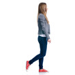 © Kabardins photo - Woman in jeans goes walking on white background. Isolation
