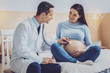 Attentive medical worker examining pregnancy