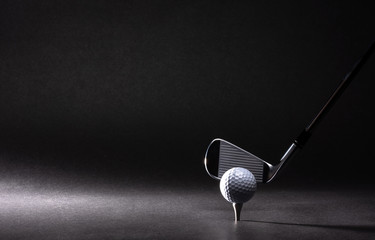 Wall Mural - Golf ball, tee and iron on black background