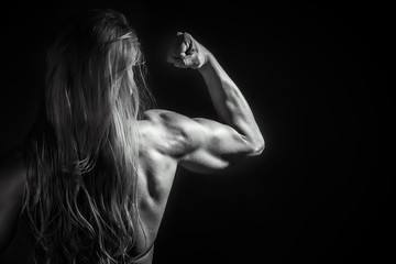 very muscular handsome athletic woman on black background