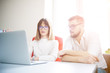 © alipko - Two coworkers using laptop