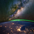 Chicago and lake Michigan from space at night, with the aurora Borealis and the Milky Way. Elements of this image furnished by NASA. 