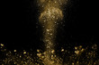 © kitsana - Golden powder explosion on black background. Freeze motion.