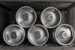 Metal beer kegs lie in a row