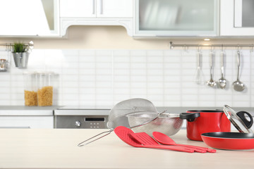 Wall Mural - Set of clean cookware and utensils on table in kitchen. Space for text