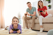 © New Africa - Happy family playing video games in living room
