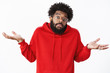 © Cookie Studio - How do I know. Portrait of clueless and unaware unbothered african-american male coworker with beard in glasses and red hoodie, shrugging with hands spread sideways, raising eyebrows in confusion