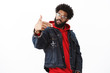 © Cookie Studio - Yo my outfit lit. Portrait of cool and stylish self-satisfied confident man with beard and afro hairstyle reading rap making gun gesture as singing hip-hop tilting head posing over gray background