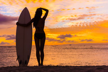 Hawaii Surf Surfer Girl Relaxing On Beach With Surfboard Looking At Waves After Surfing. Silhouette Of Bikini Woman Standing With Surf Board.