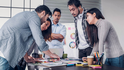 Wall Mural - creative director team lead standing brainstrom branding project with designer team at meeting table