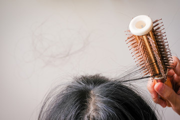 Wall Mural - hair fall and lost alopecia woman problem on the comb.