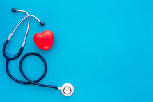 Heart Health, Health Care Concept. Stethoscope Near Rubber Heart On Blue Background Top View Space For Text