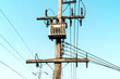 © Nuttapon - Transformer transmission electricity convert high voltage to low voltage, Power supply transformer reduce voltage, Electricity pole in rural countryside, Distribution Transformer reduction on blue sky